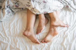 a couple cuddling in bed